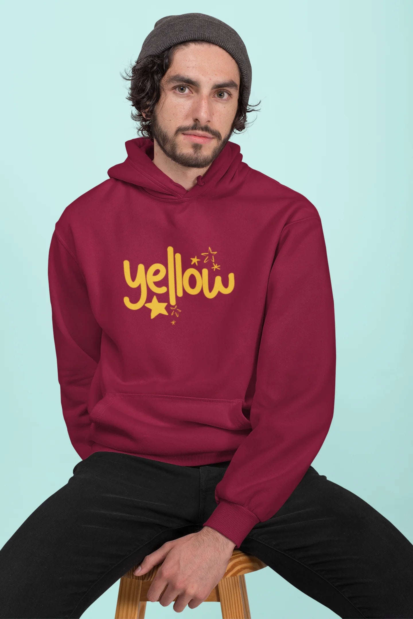 First front view of a male model wearing a maroon hoodie with the "Yellow" album artwork by Coldplay.