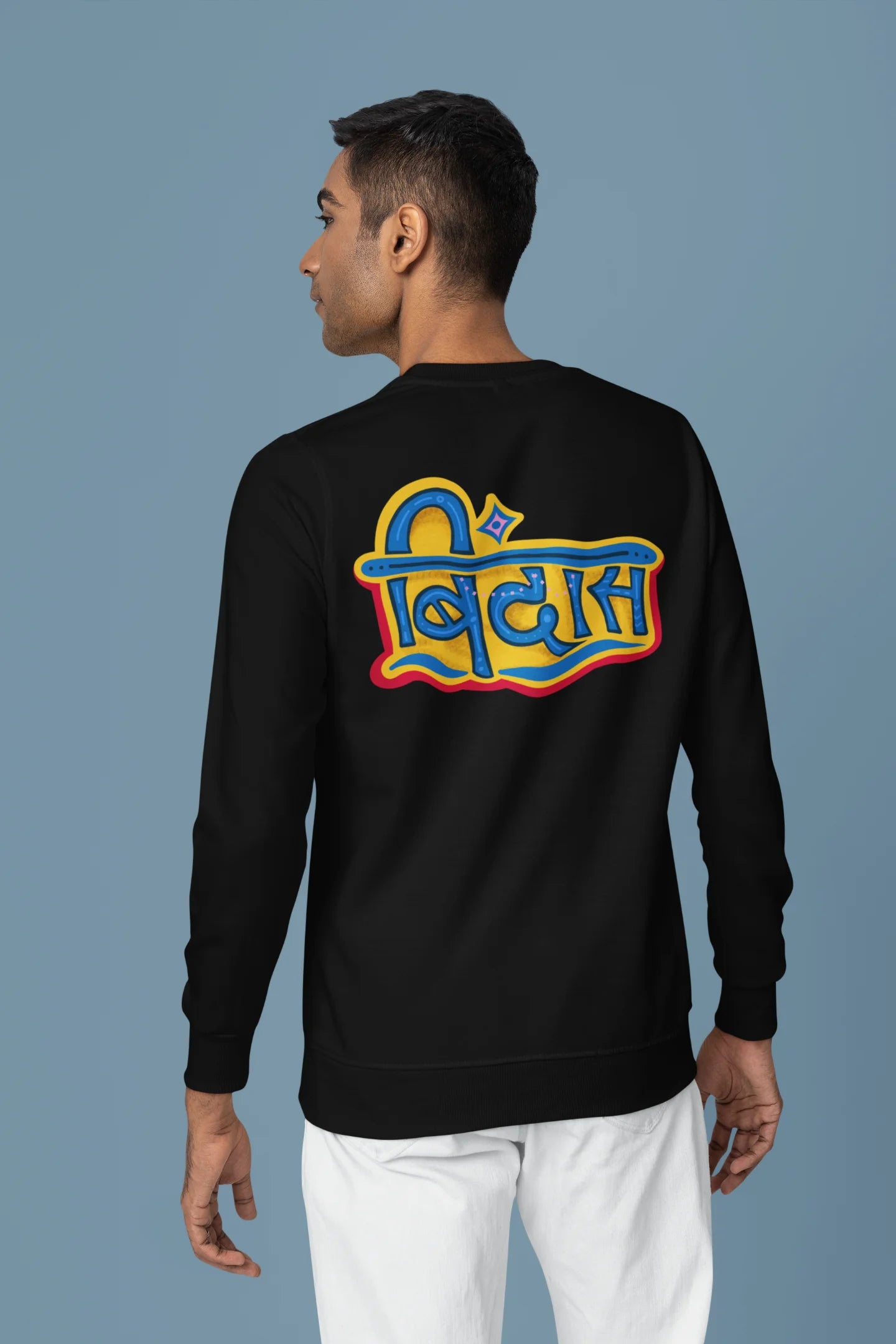 Back view of a male model wearing a black sweatshirt featuring "Bindass" in a stylish Hindi font.