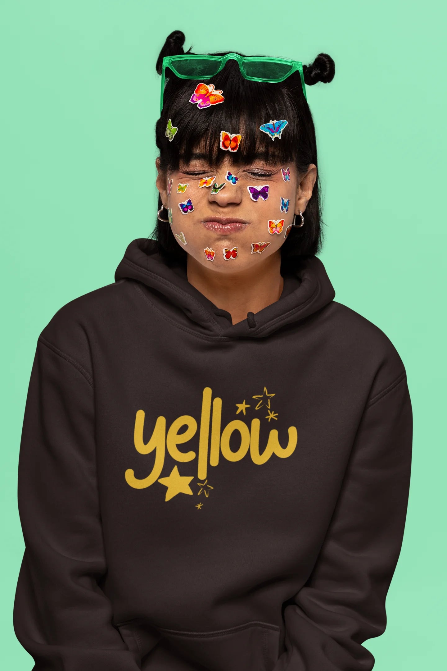 6th front view of a female model wearing a chocolate brown hoodie with the "Yellow" album artwork by Coldplay.
