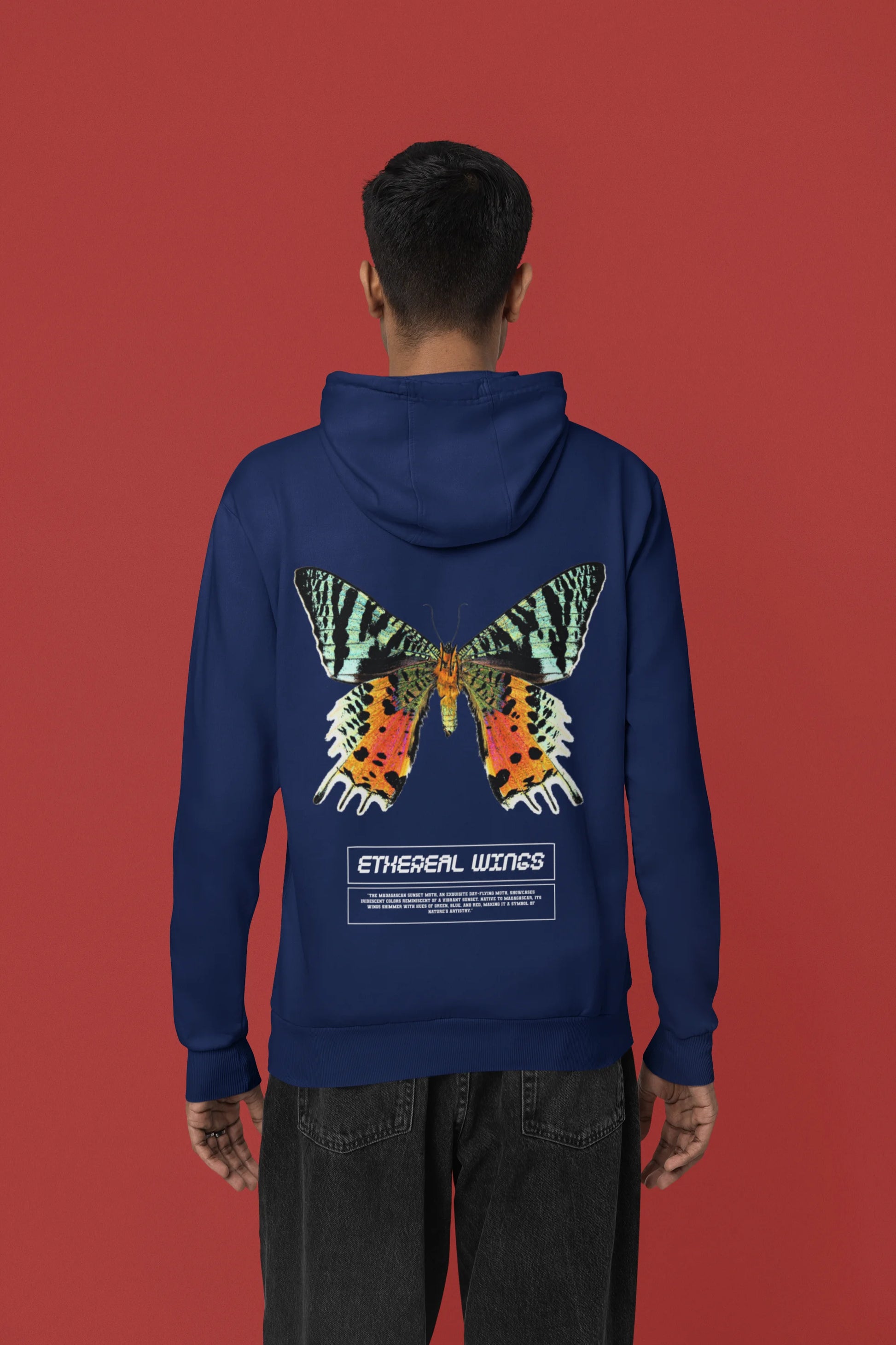 Back view of a male model wearing a navy blue hoodie with a glowing butterfly design, symbolizing the ethereal beauty of nature.