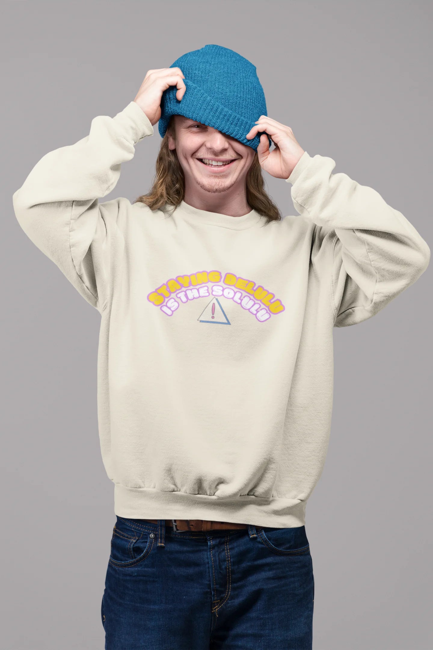 2nd front view of male model wearing a cream sweatshirt with the hilarious message "Stay Delulu" in a bold design. Ideal for those who love trendy slang and lighthearted humor.