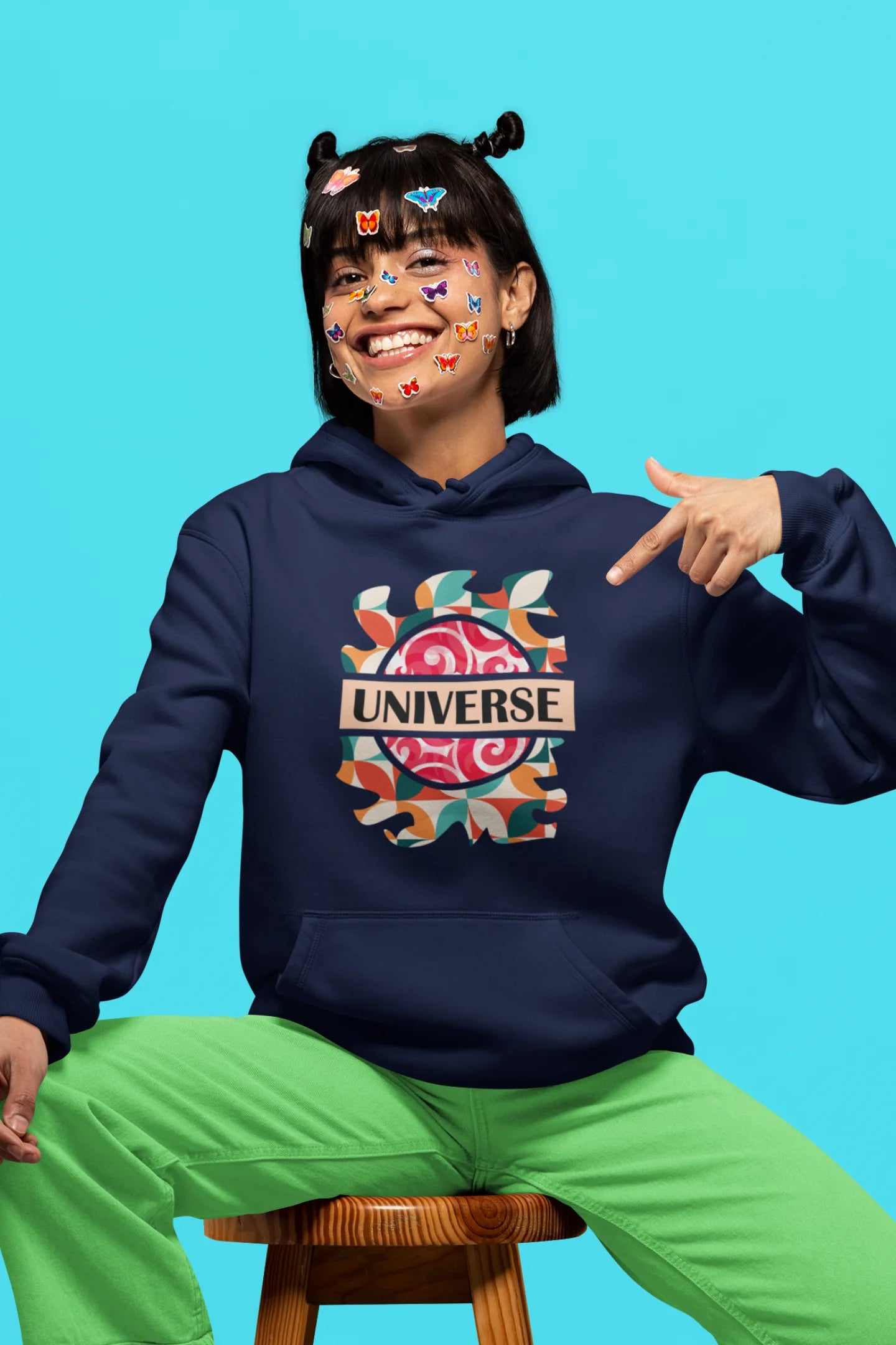 3rd front view of a female model wearing an royal blue hoodie with a cosmic Universe design inspired by Coldplay.