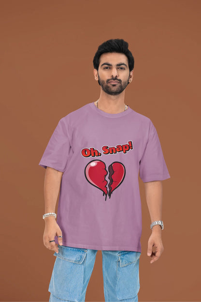 3rd front view of a male model wearing a dirty purple oversized t-shirt with the text "Oh Snap!" and a broken heart symbol underneath.