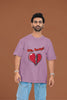 3rd front view of a male model wearing a dirty purple oversized t-shirt with the text 