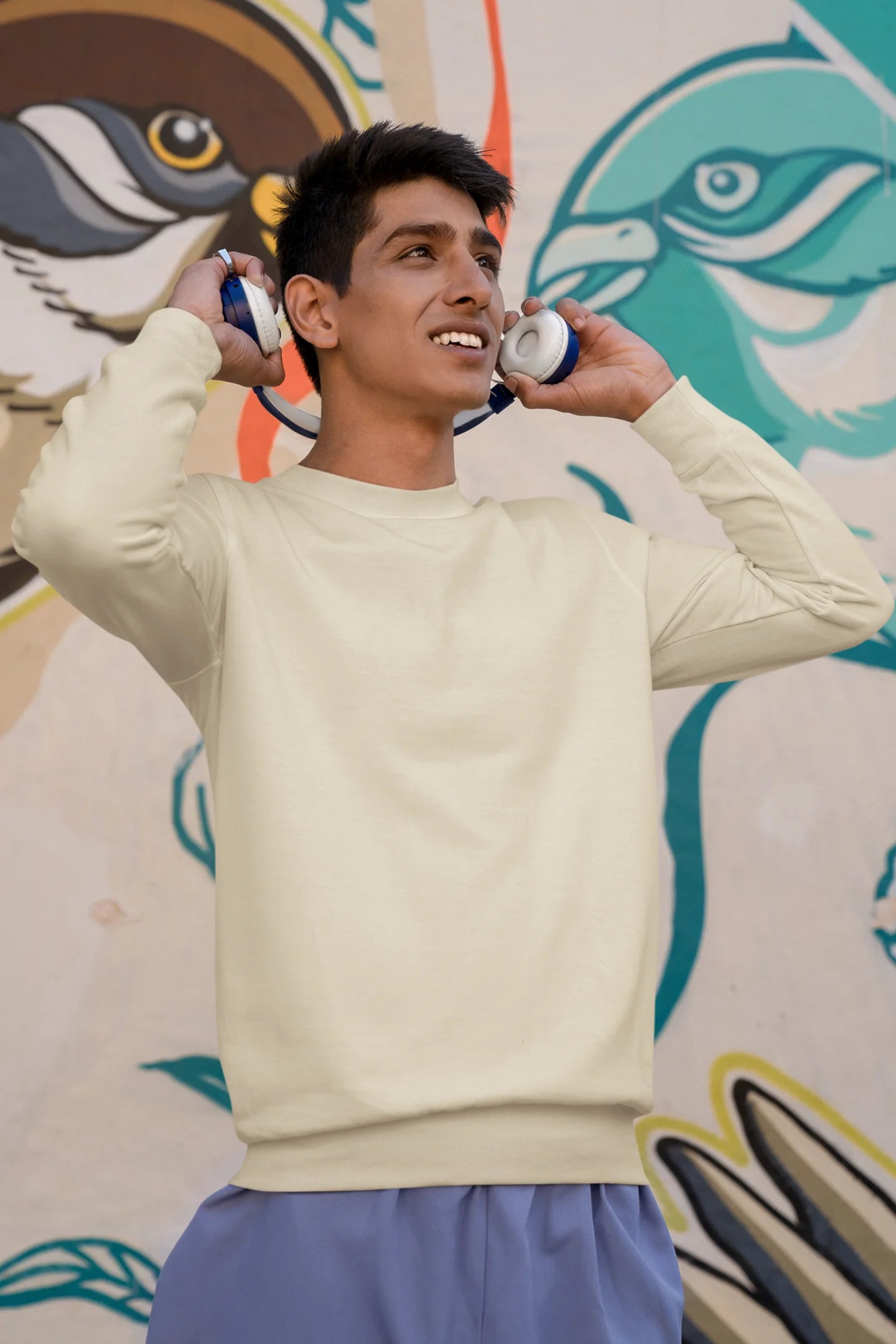 Second front view of male model wearing a cream F.R.I.E.N.D.S. sweatshirt featuring a design inspired by Joey Tribbiani's funny quotes and signature charm.