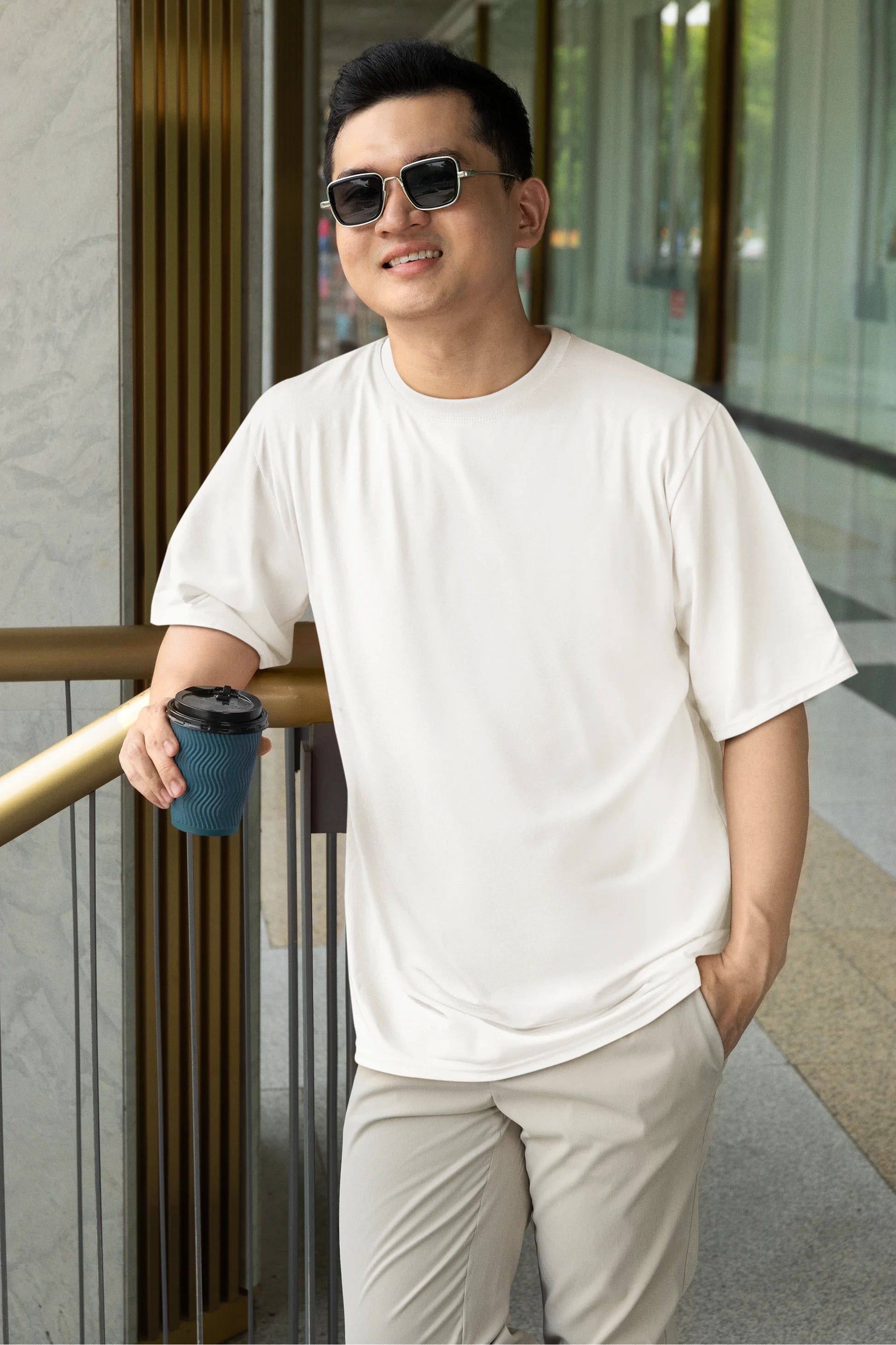 Front view of a male model wearing a off-white oversized tee with a design of a fox and its cub in a traditional Japanese landscape.