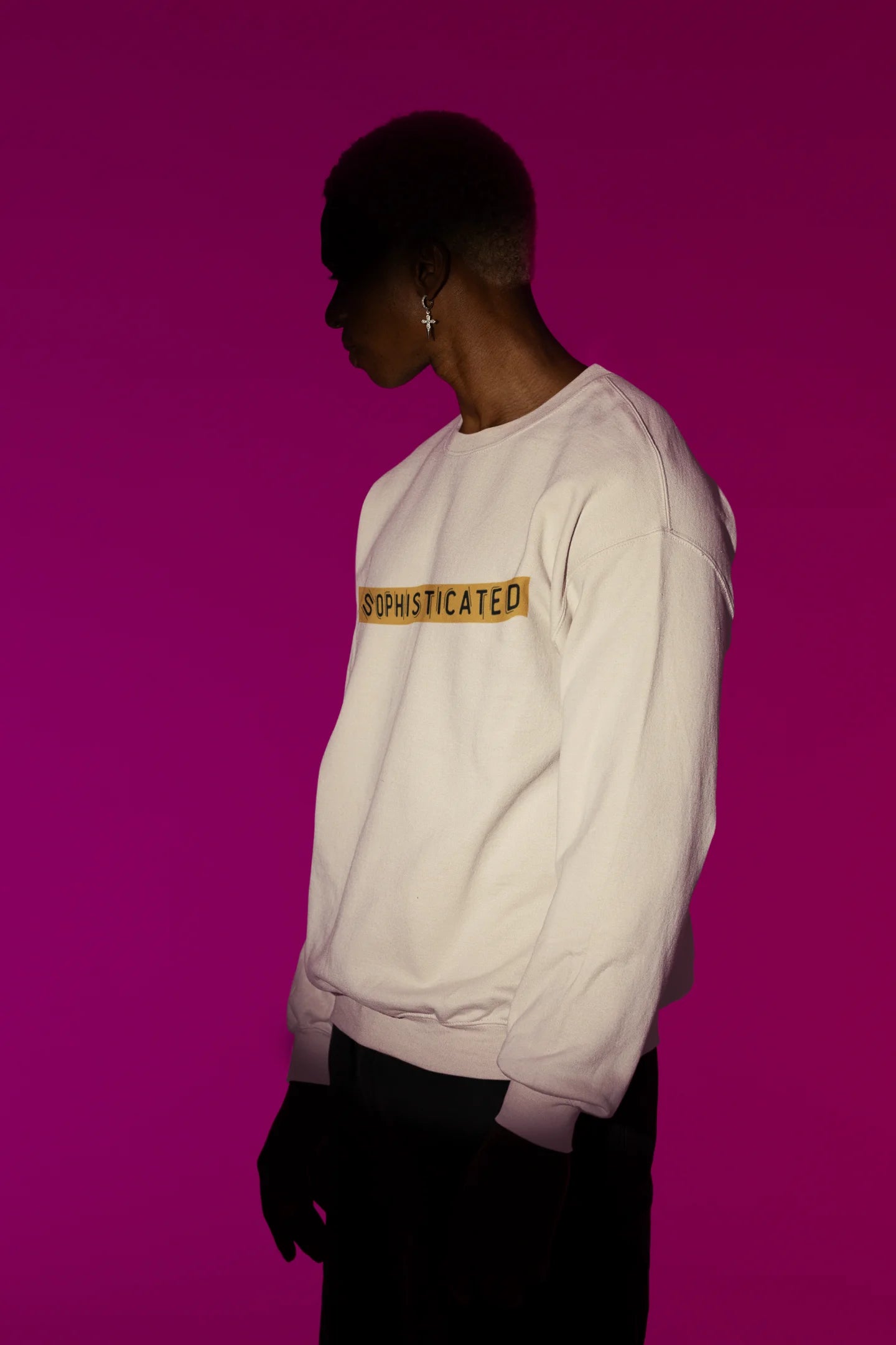 Second front view of a male model wearing a cream sweatshirt with a sophisticated brutalist design featuring a Greek god statue.