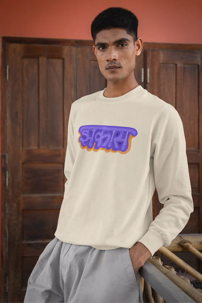 3rd front view of a male model wearing an cream sweatshirt featuring "Jhakas" in a stylish font.