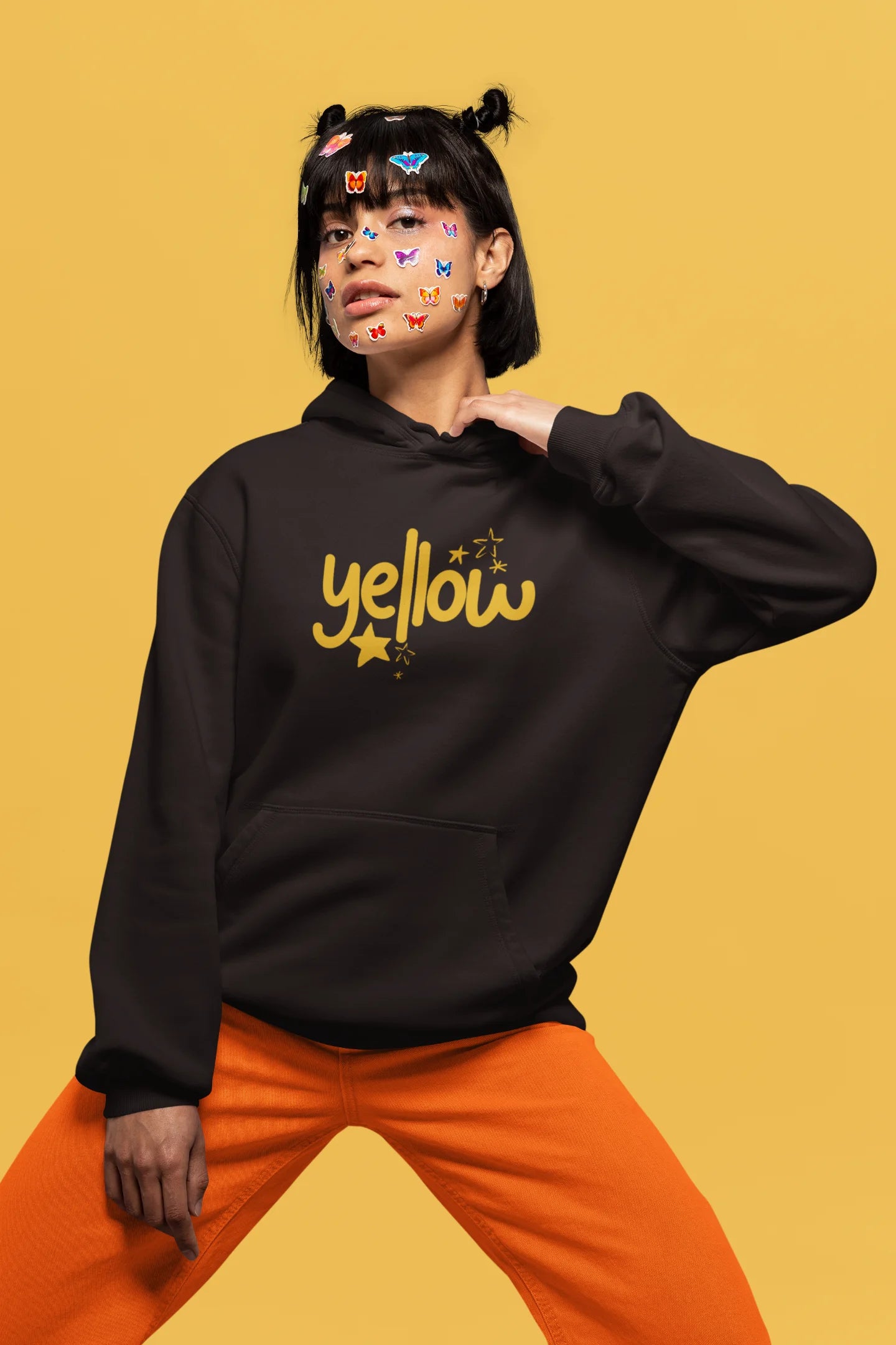 4th front view of a female model wearing a chocolate brown hoodie with the "Yellow" album artwork by Coldplay.
