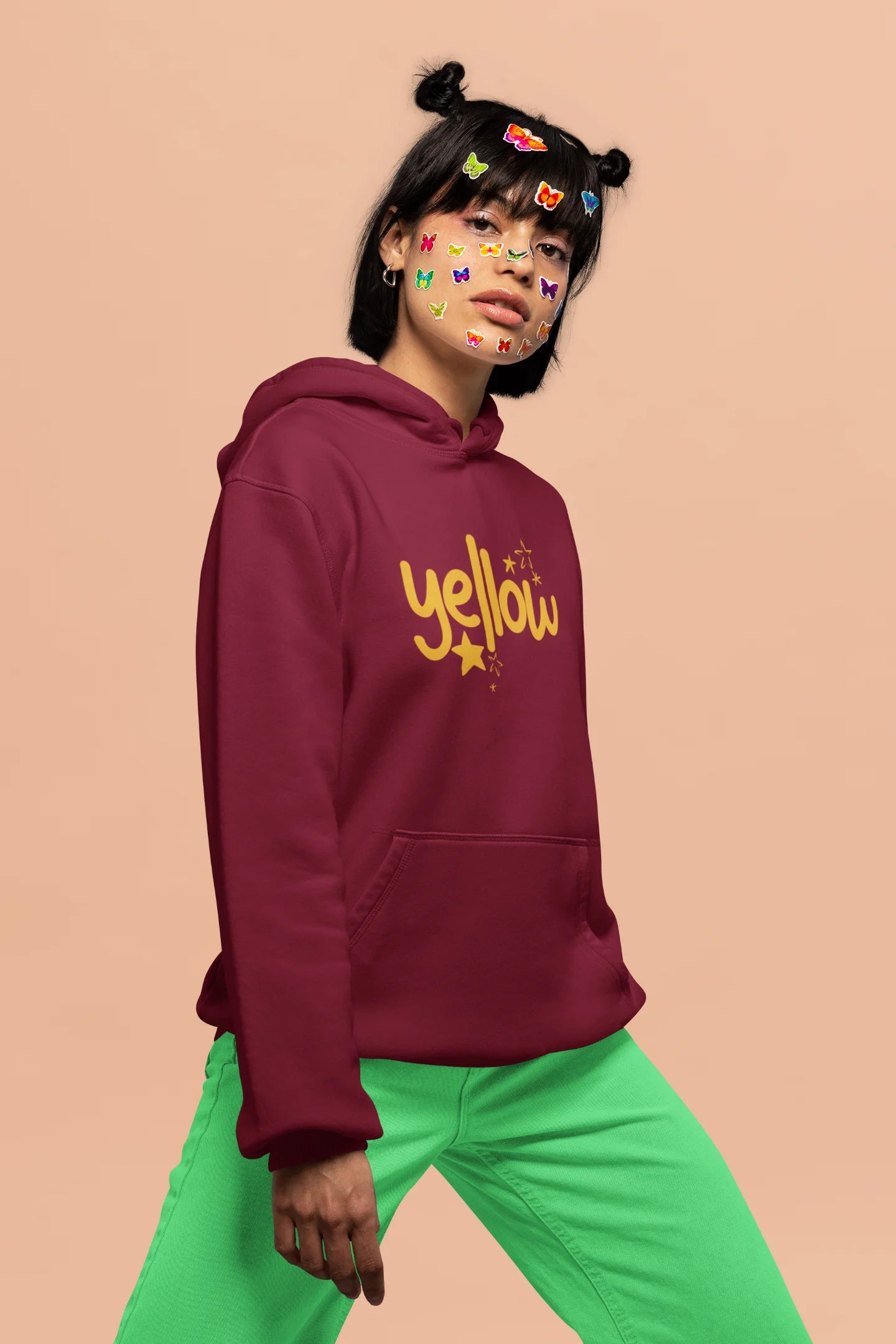 5th front view of a female model wearing a maroon hoodie with the "Yellow" album artwork by Coldplay.