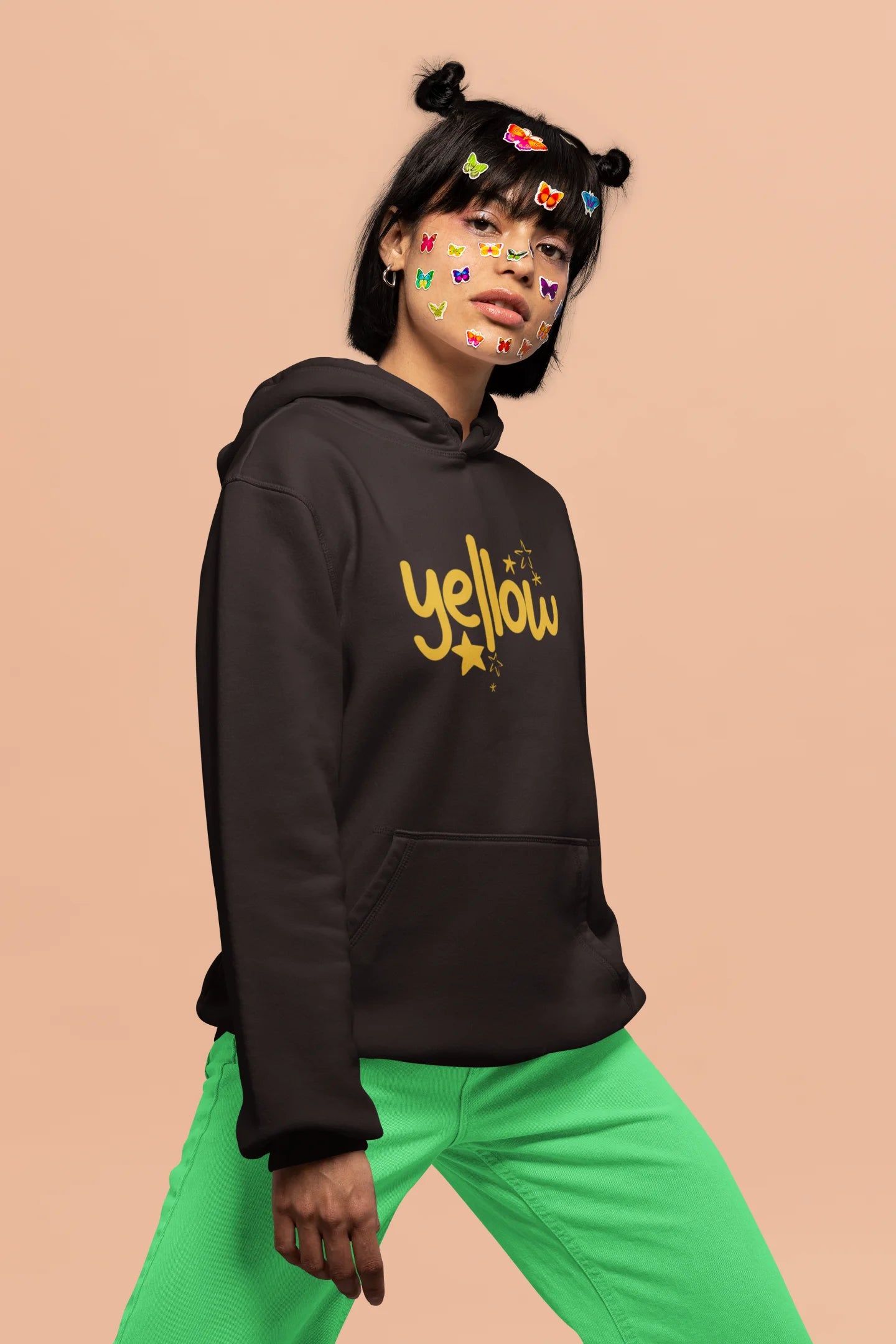 3rd front view of a female model wearing a chocolate brown hoodie with the "Yellow" album artwork by Coldplay.