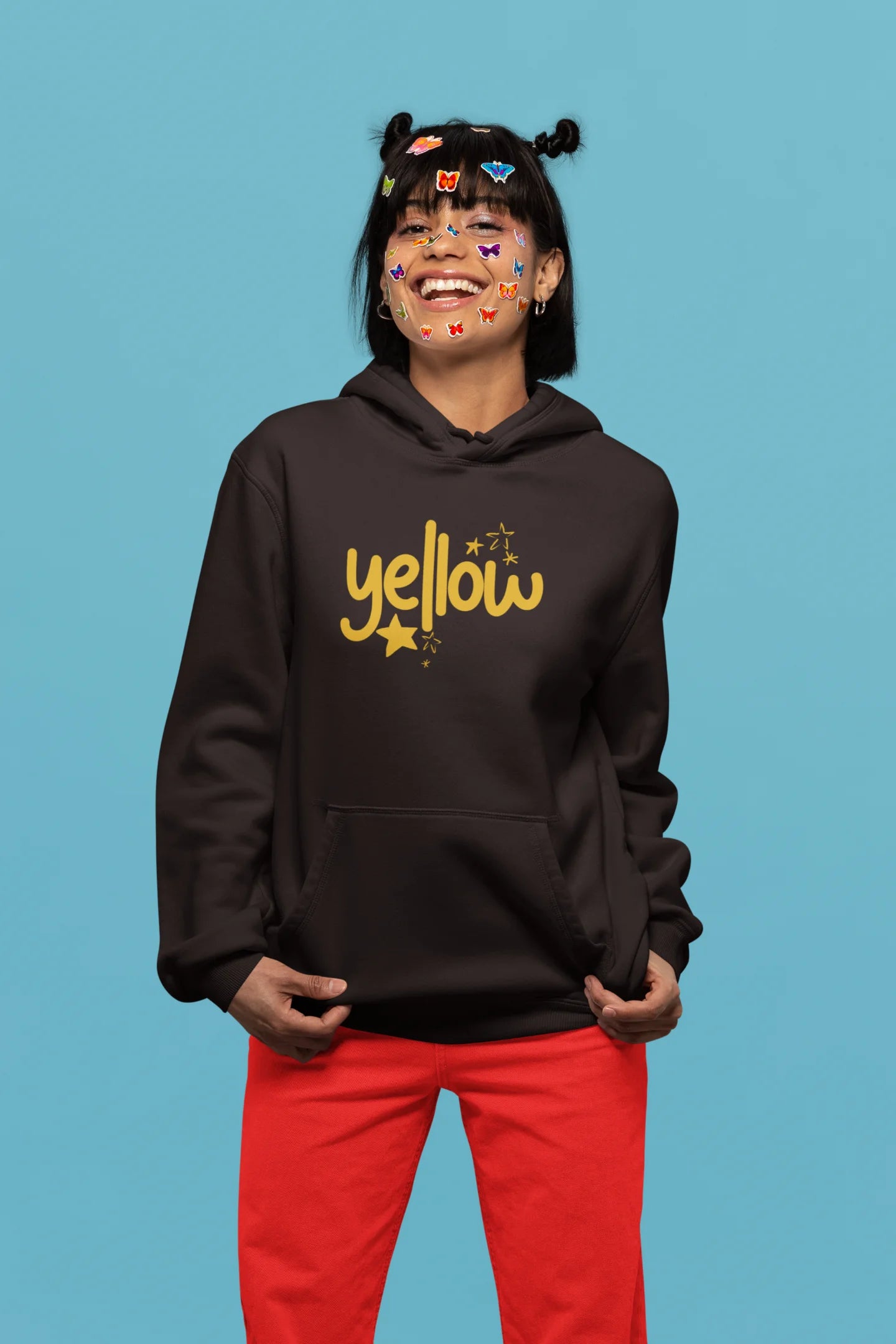 First front view of a female model wearing a chocolate brown hoodie with the "Yellow" album artwork by Coldplay.