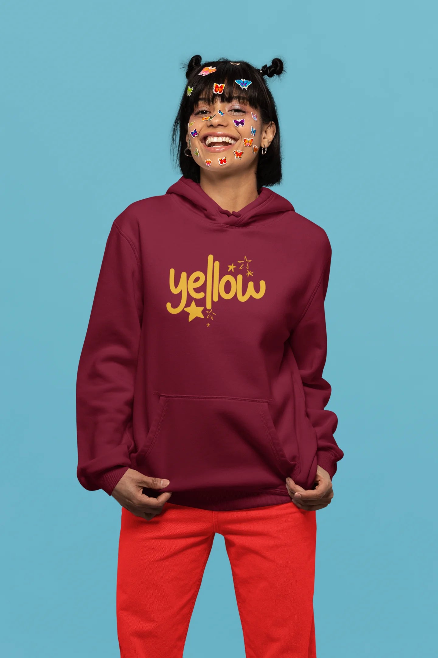 3rd front view of a female model wearing a maroon hoodie with the "Yellow" album artwork by Coldplay.