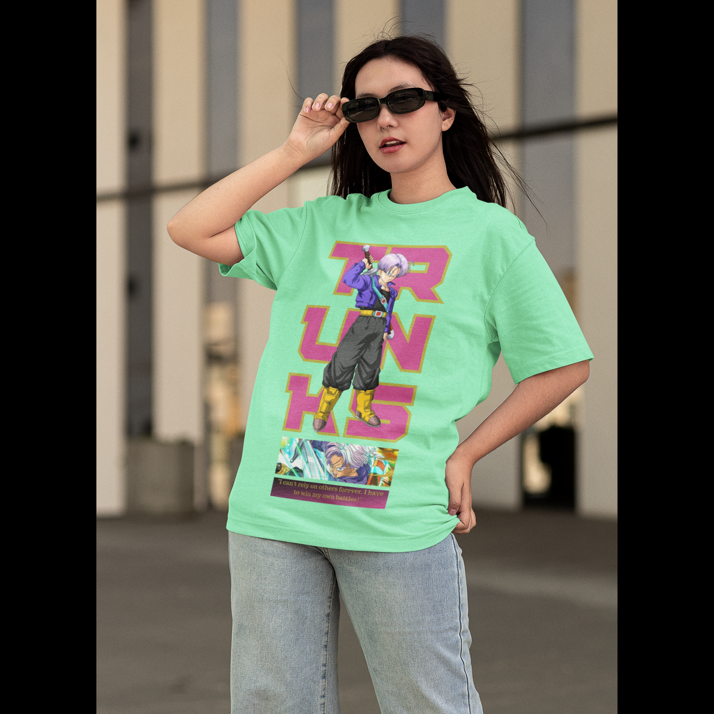 First front view of a female model wearing a mint green oversized t-shirt featuring Trunks from Dragon Ball Z with the text "Trunks."