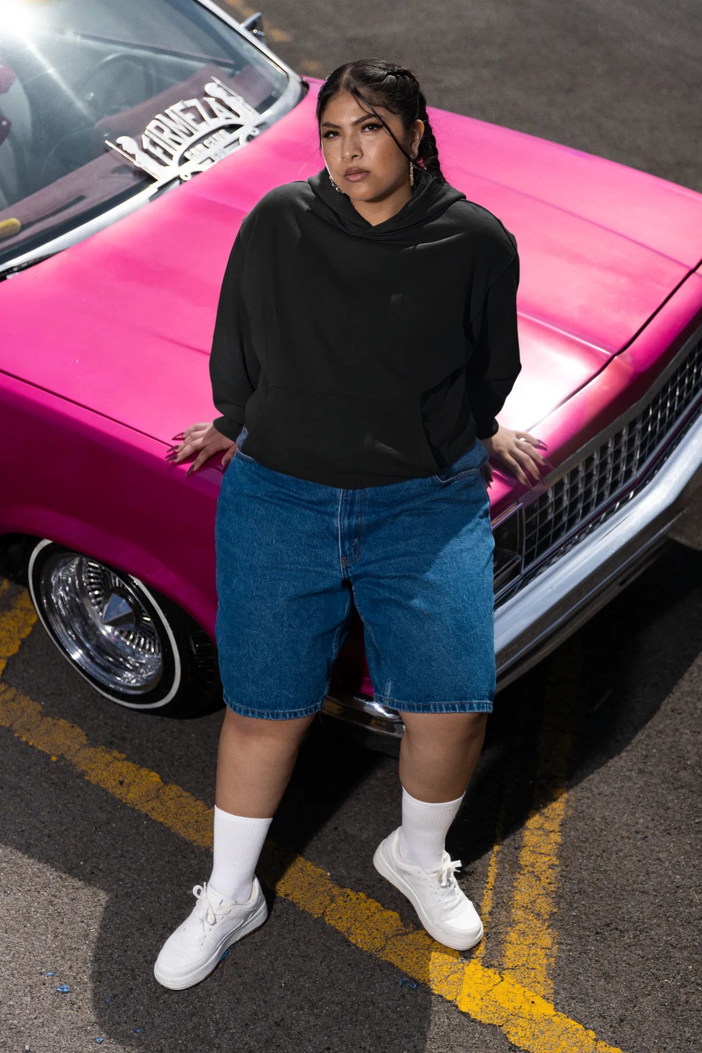 Second front of a female model wearing a black hoodie featuring a Range Rover Defender design, exuding power and ruggedness.