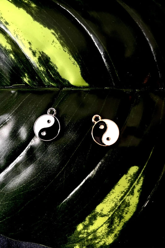 First image of a couples yin and yang charms symbolizing a balanced approach towards eternal love.