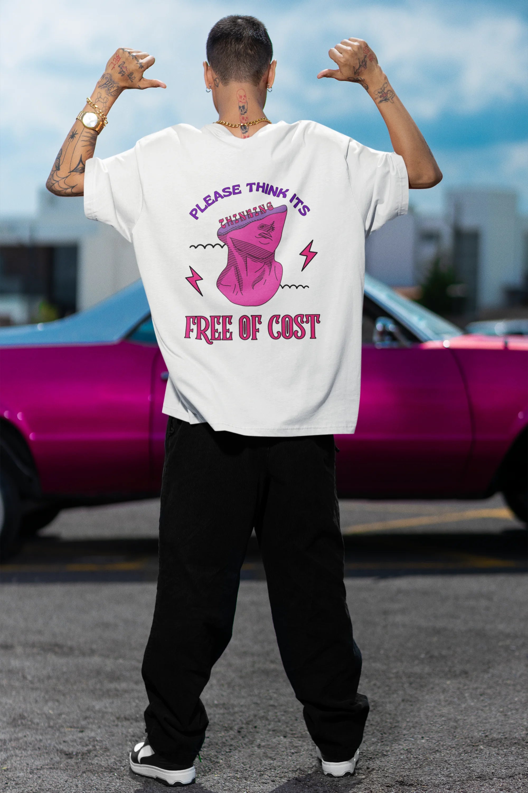 Back view of a male model wearing an off-white oversized t-shirt featuring a thought-provoking design of a man's bust with the text "Think It's Free of Cost." Ideal for those who love funny clothing and the importance of mindful communication.