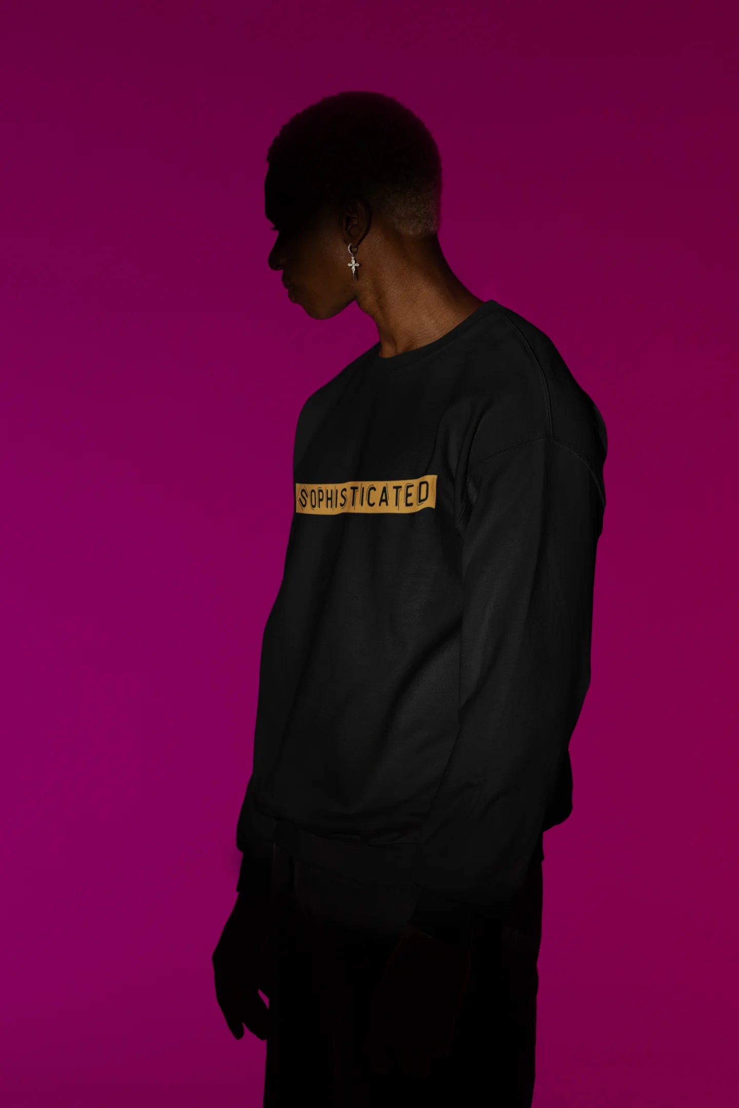 Second front view of a male model wearing a black sweatshirt with a sophisticated brutalist design featuring a Greek god statue.