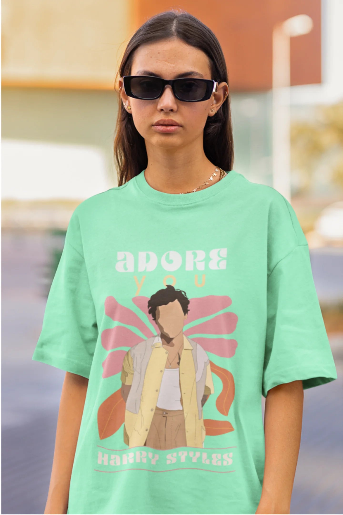 Third image of woman wearing mint green oversized t-shirt featuring 'Adore You' inspired design - ideal for fans of Harry Styles and One Direction