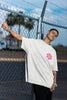 Left side view of a male model wearing an oversized off-white t-shirt with a positive message 