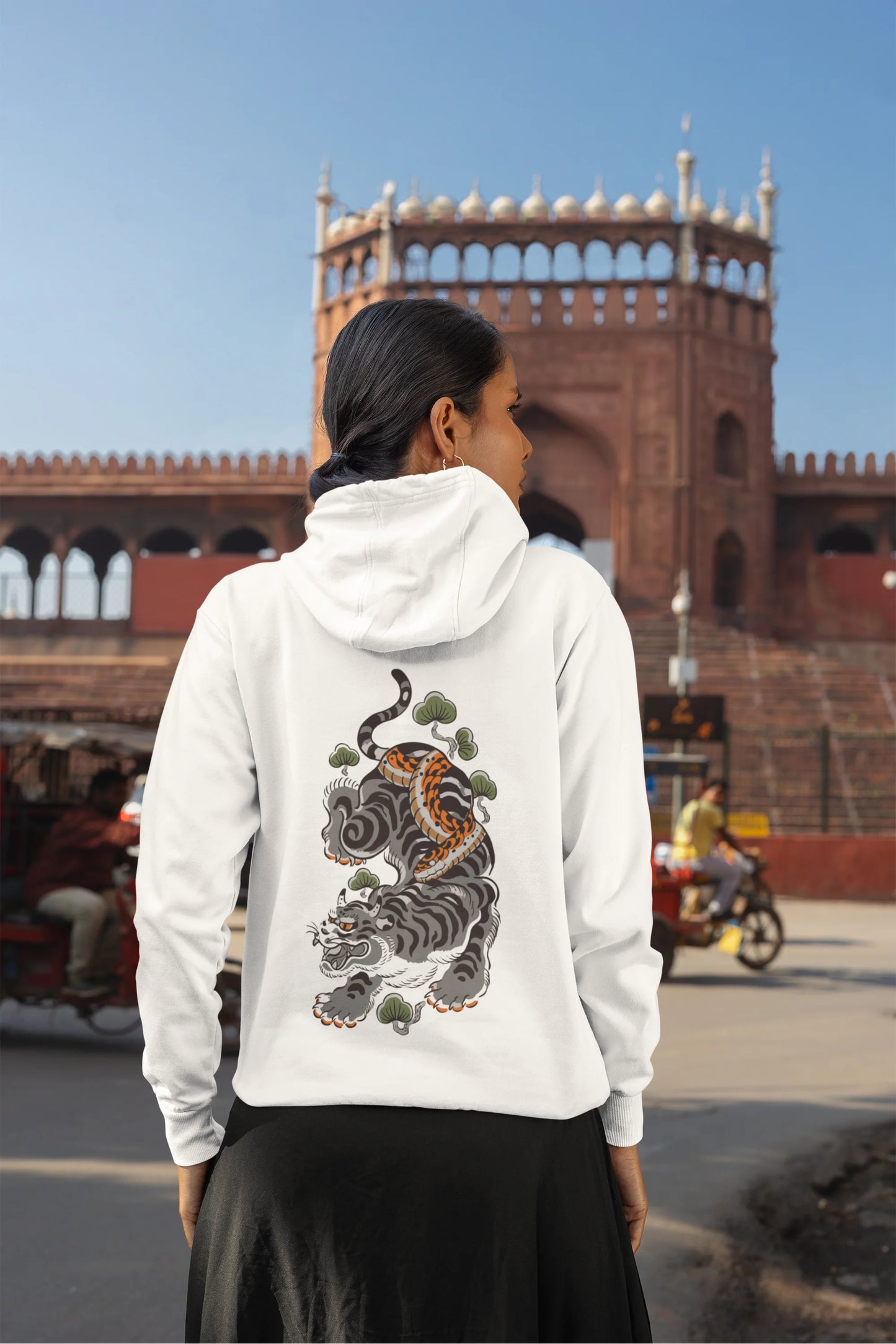 Back view of a female model wearing a white hoodie with a Japanese art style tiger design.