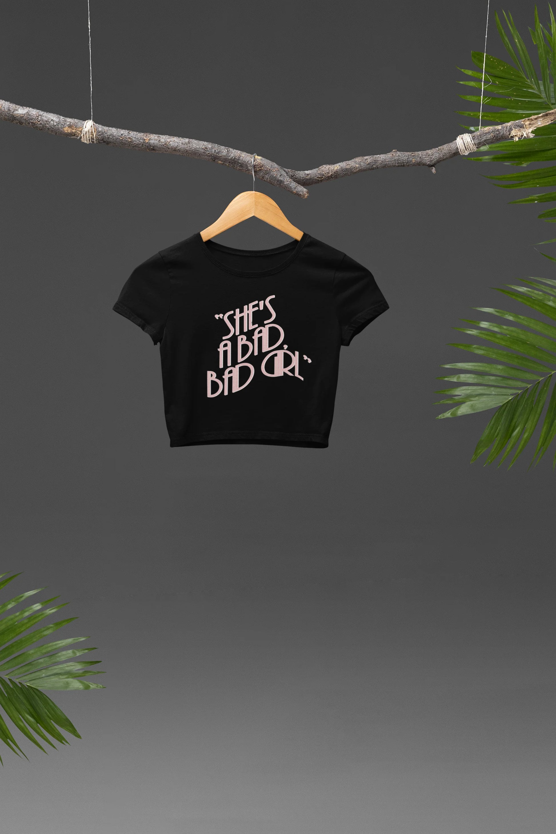 Front view of a Black crop top with "She's a bad bad girl" text, perfect for Swifties and Eras Tour fans.