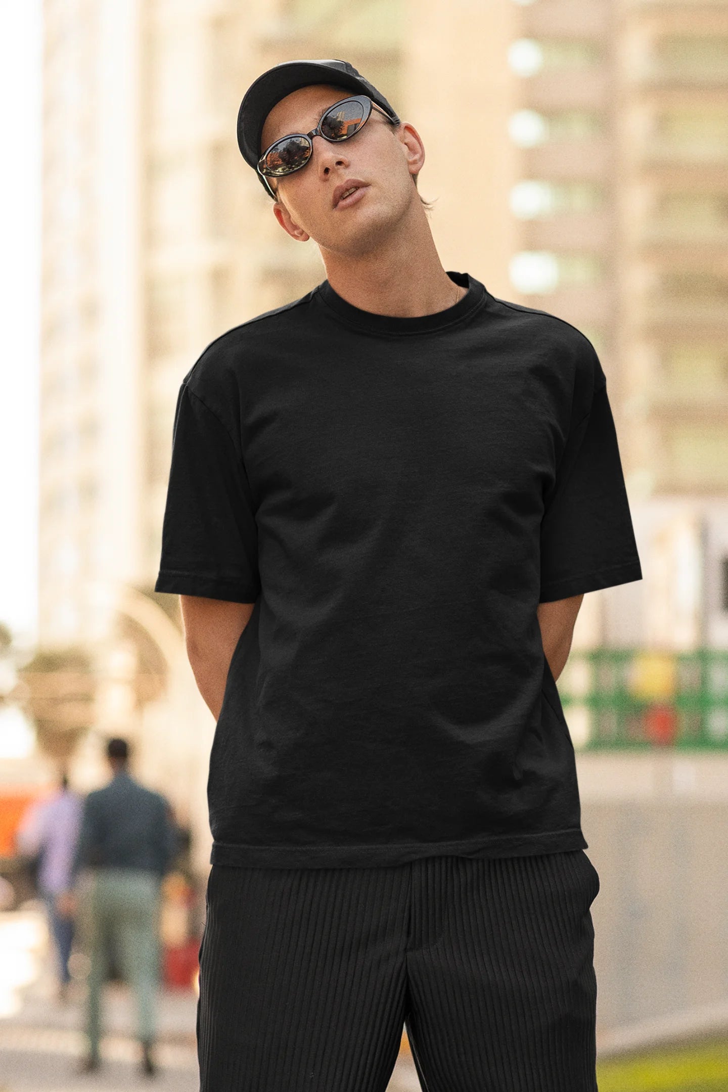 Front view of man wearing black Oversize Taylor Swift T-Shirt featuring Fortnight Theme on its back