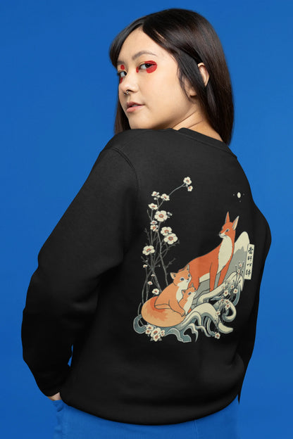 Back view female model wearing a black sweatshirt with a design of a fox and its cub in a traditional Japanese landscape.