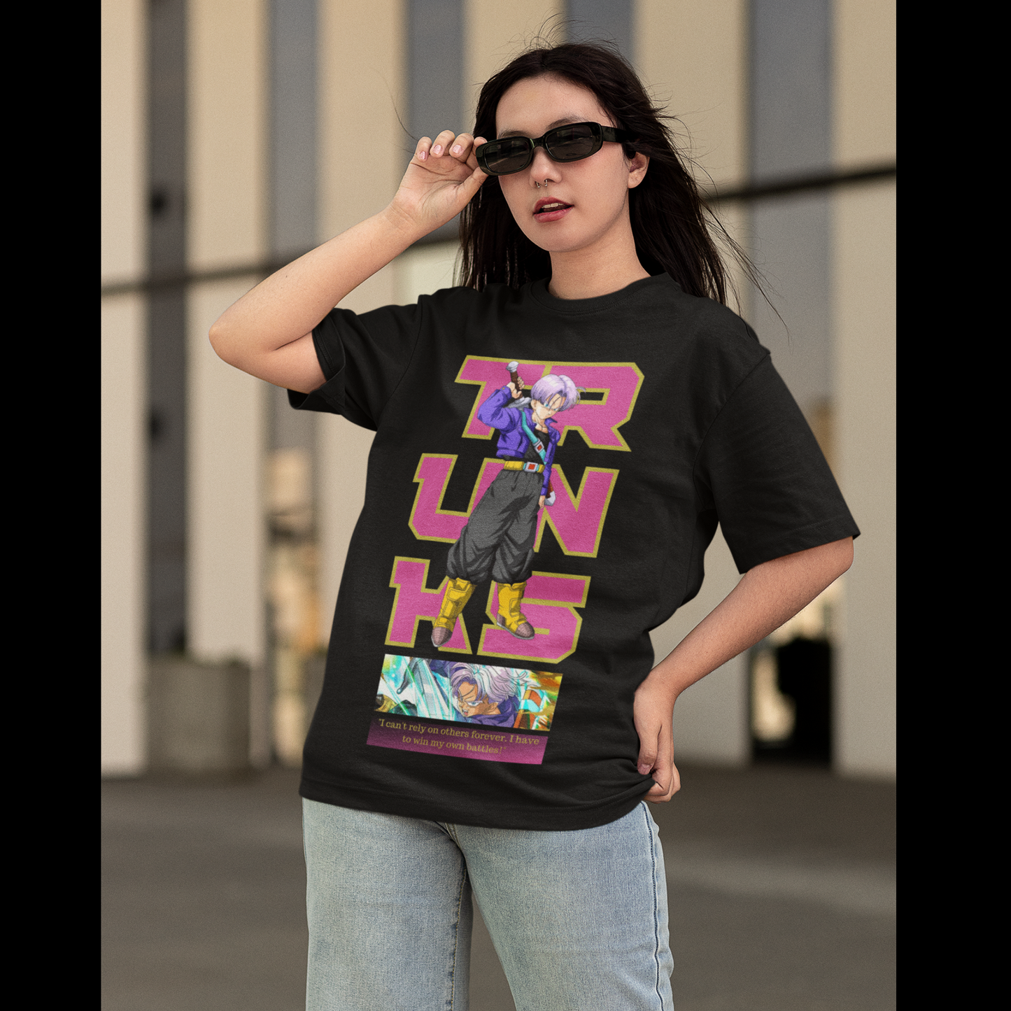 First front view of a female model wearing a black oversized t-shirt featuring Trunks from Dragon Ball Z with the text "Trunks."