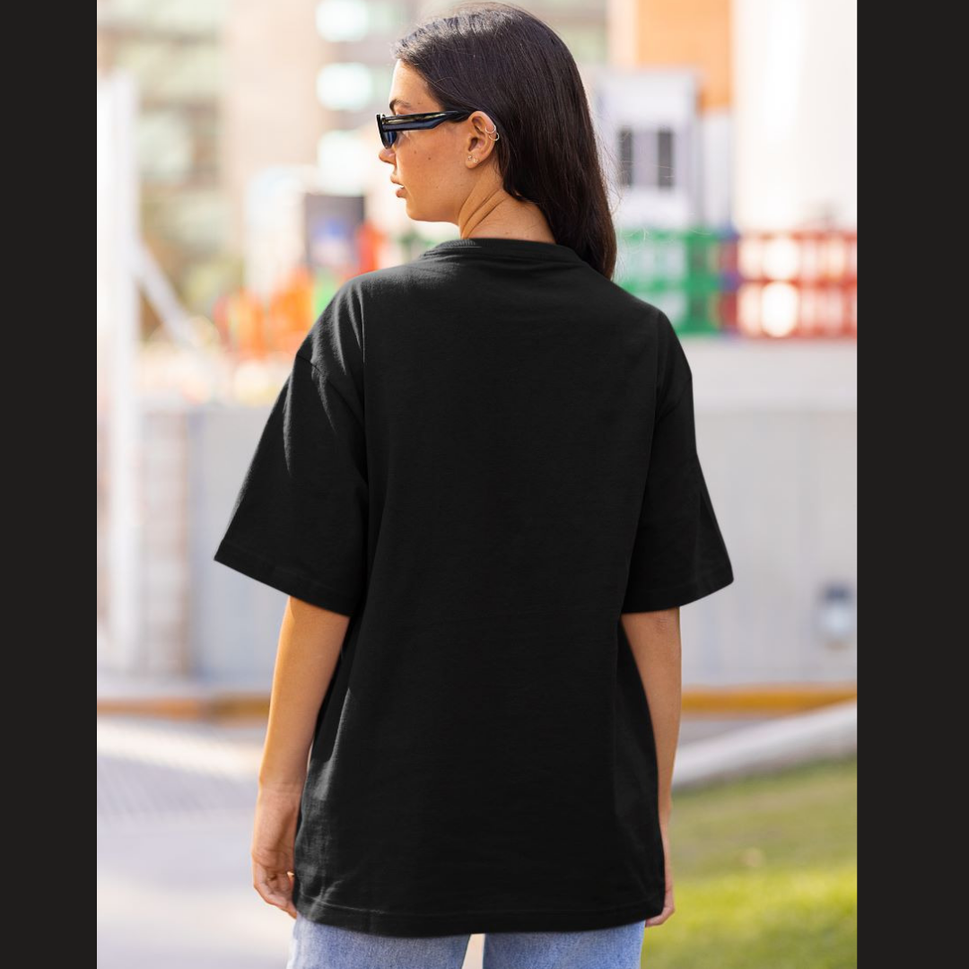Back view of a female model wearing a black oversized t-shirt featuring Tanjiro Kamado from Demon Slayer: Kimetsu no Yaiba.