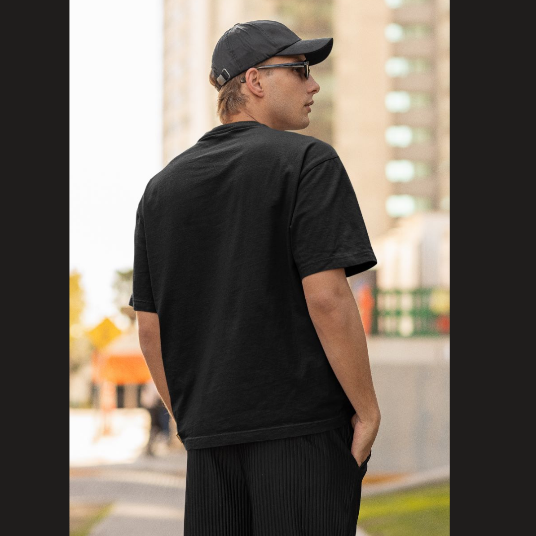 Back view of a male model wearing a black oversized t-shirt featuring Tanjiro Kamado from Demon Slayer: Kimetsu no Yaiba.