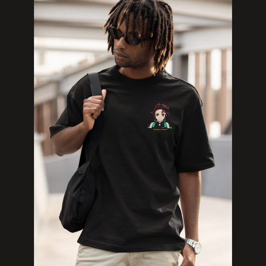 Front view of a male model wearing a black oversized t-shirt featuring Tanjiro Kamado with the text "Demon Slayer."