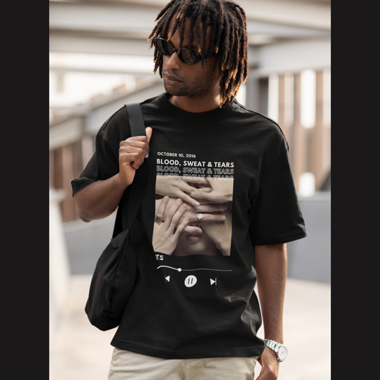 Front view of a male model wearing a black oversized t-shirt featuring a design inspired by BTS's music video "Blood, Sweat & Tears." Ideal for BTS fans (ARMY) who want to celebrate this iconic era.