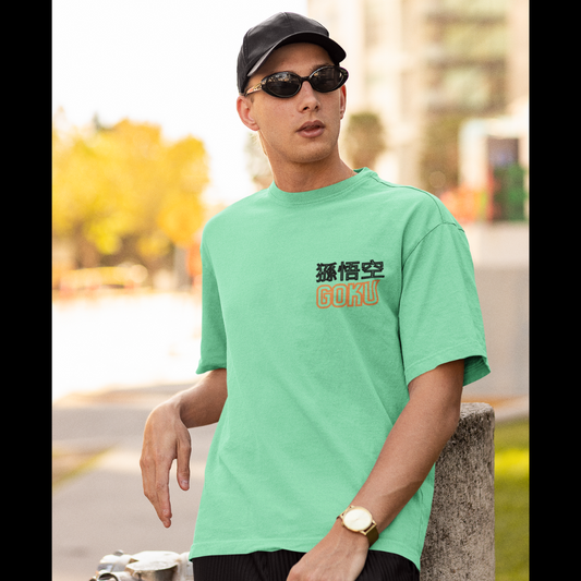 Front view of a male model wearing a mint green oversized t-shirt featuring a young Goku from Dragon Ball Z with the text "Young Goku."