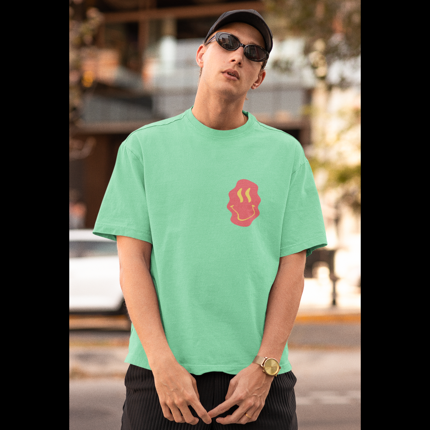 Front view of a male model wearing a mint green oversized t-shirt featuring a fun "Space Wreck" design with elements of spaceships, UFOs, and a hint of extraterrestrial life.