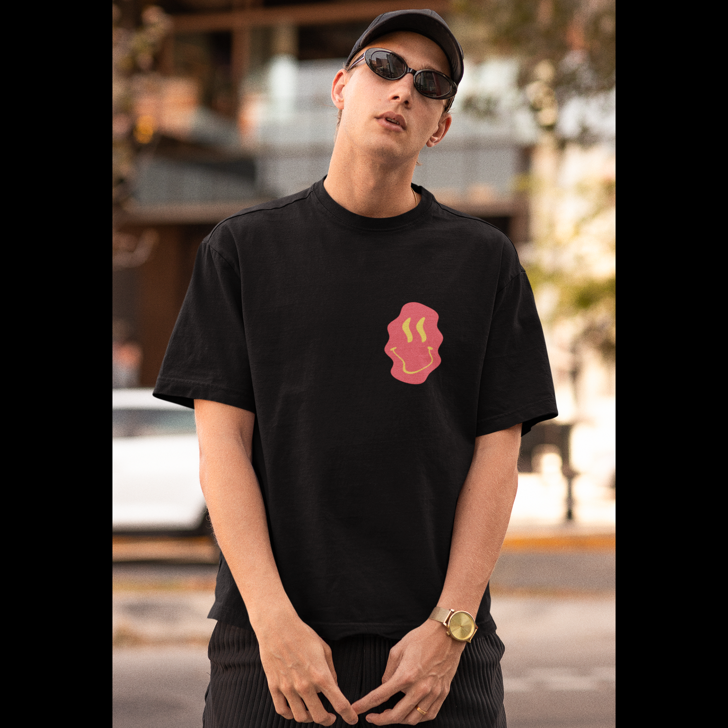 Front view of a male model wearing a black oversized t-shirt featuring a fun "Space Wreck" design with elements of spaceships, UFOs, and a hint of extraterrestrial life.
