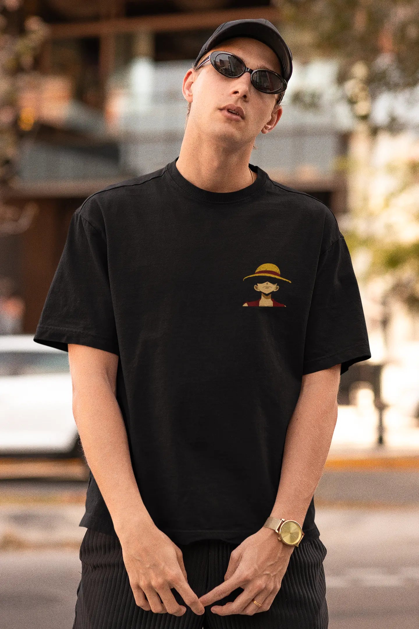 Front view of a male model wearing a black oversized t-shirt featuring Monkey D. Luffy from the One Piece anime.