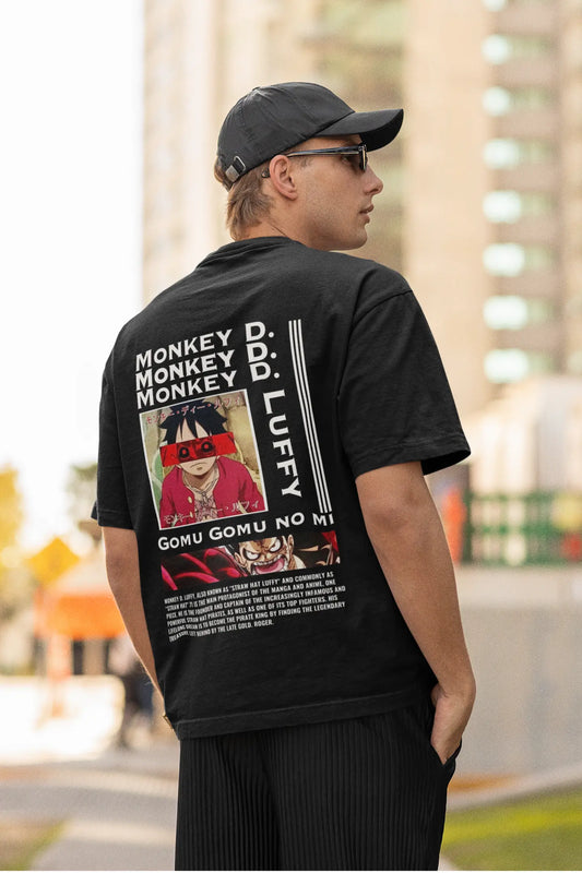 Back view of a male model wearing a black oversized t-shirt featuring Monkey D. Luffy from the One Piece anime.