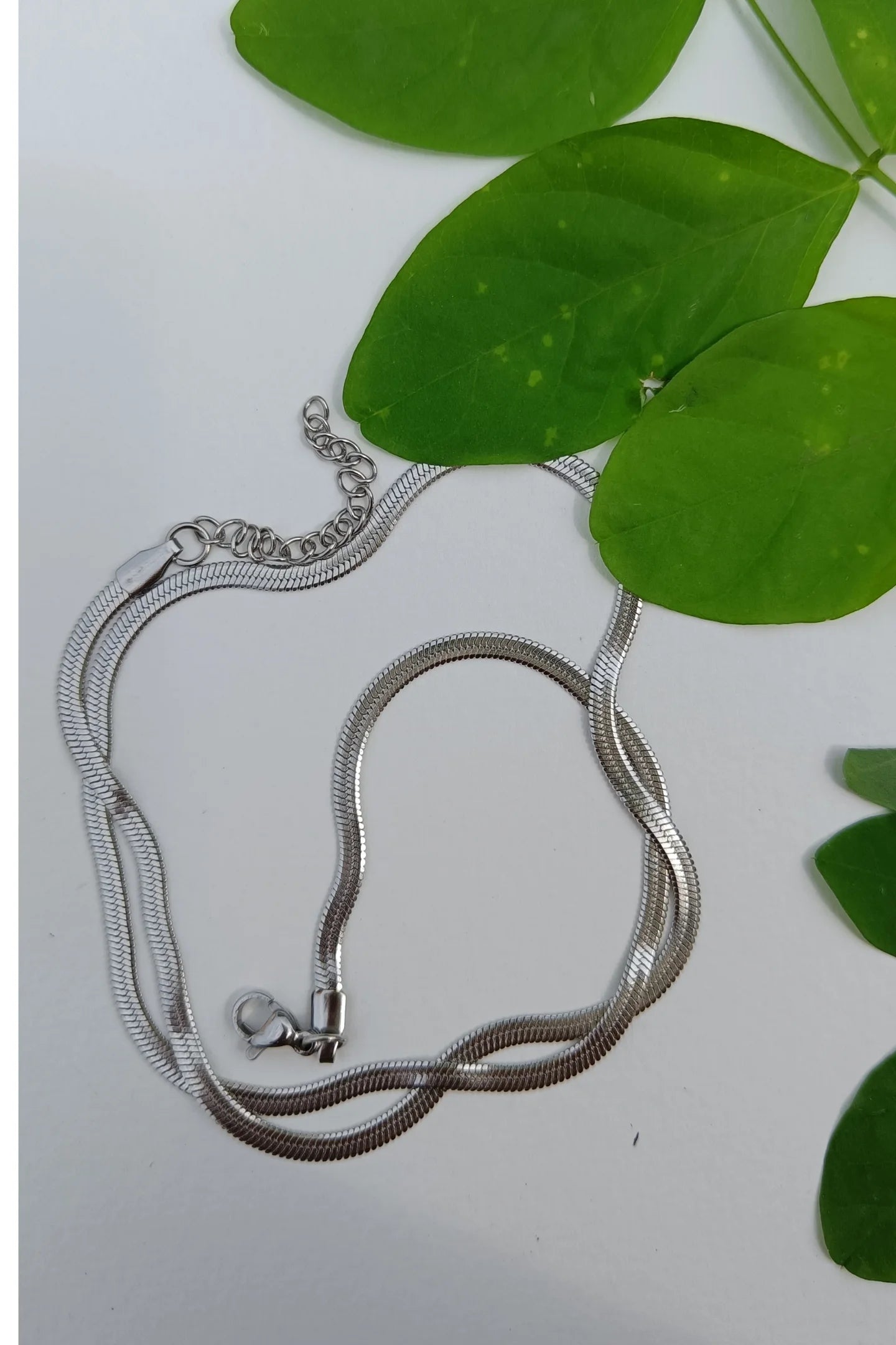 Fourth image of an anti tarnish silver chain necklace featuring a snake like design.