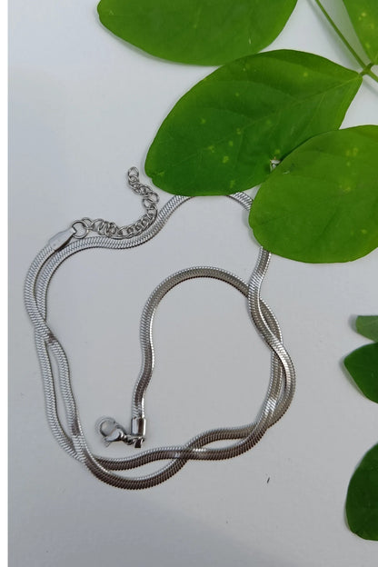 Fourth image of an anti tarnish silver chain necklace featuring a snake like design.