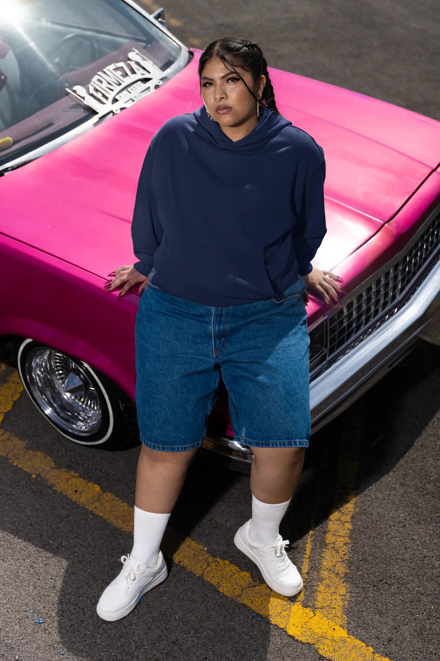 Second front of a female model wearing a navy blue hoodie featuring a Range Rover Defender design, exuding power and ruggedness.