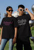 First front view of a couple wearing matching black oversize tees, one with 