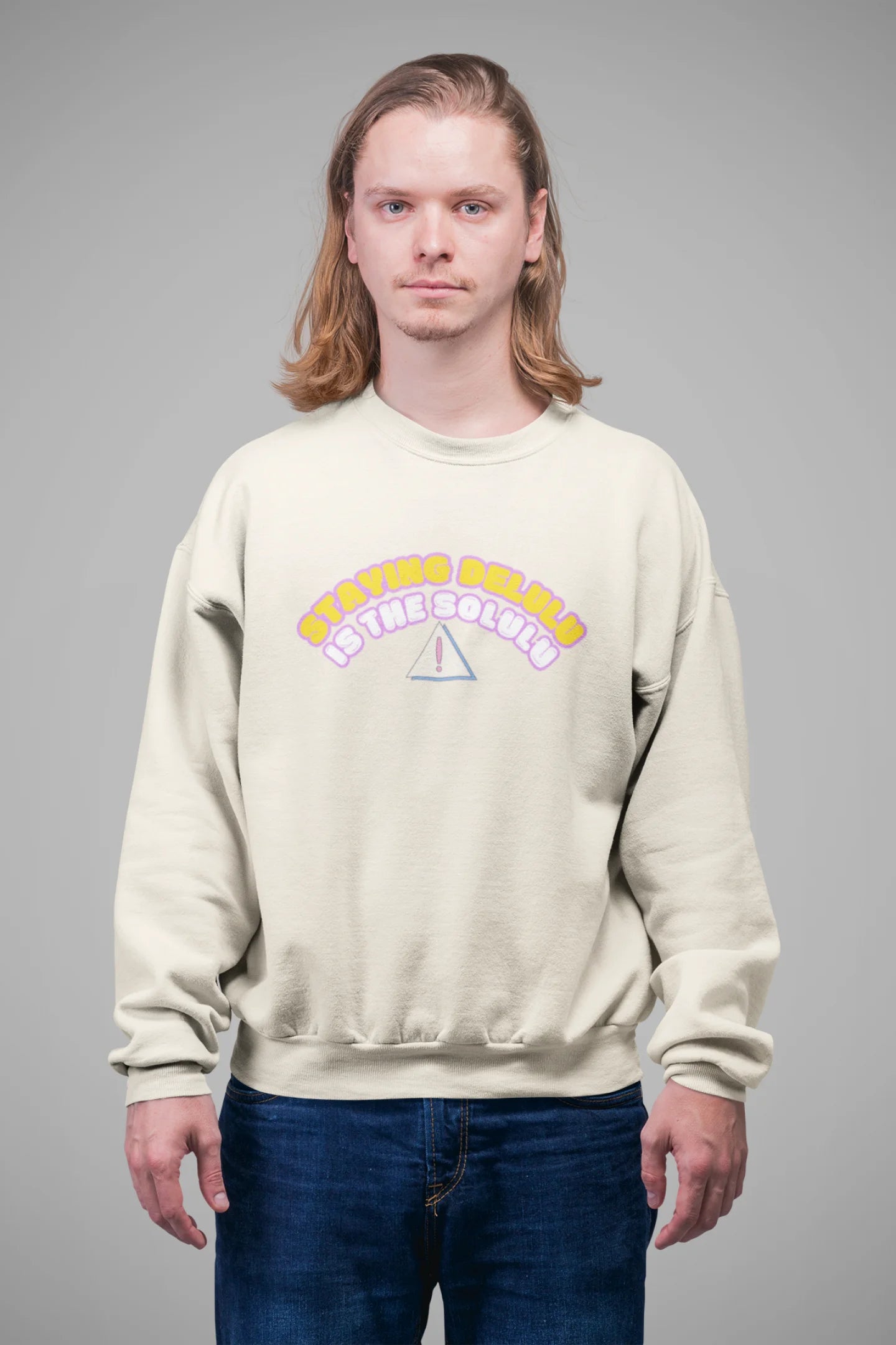 4th front view of male model wearing a cream sweatshirt with the hilarious message "Stay Delulu" in a bold design. Ideal for those who love trendy slang and lighthearted humor.