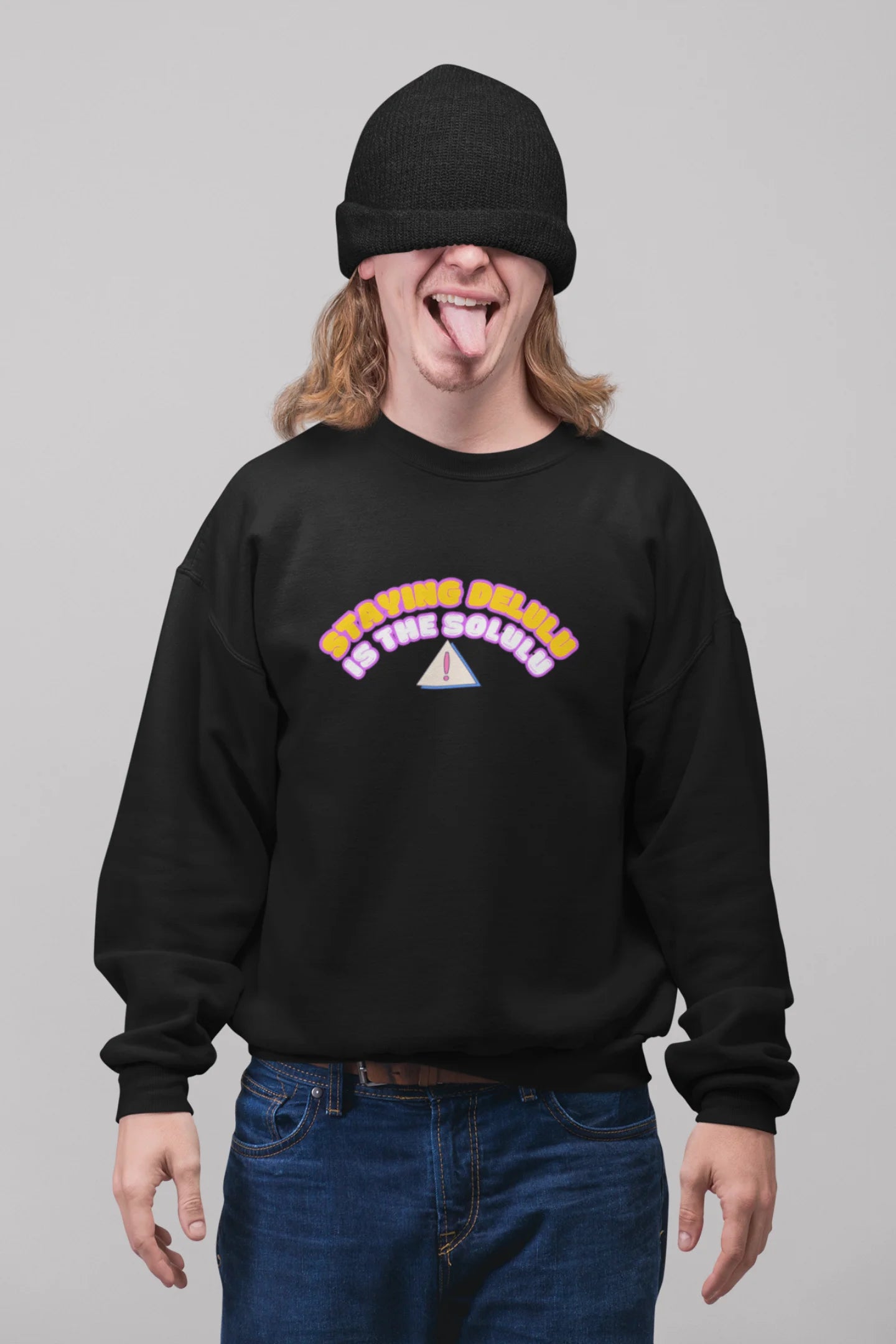 First front view of male model wearing a black sweatshirt with the hilarious message "Stay Delulu" in a bold design. Ideal for those who love trendy slang and lighthearted humor.