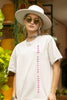 Front view of a female model wearing an off-white oversized t-shirt featuring a thought-provoking design of a man's bust with the text 