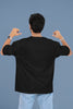 Back view of a male model wearing a black oversized t-shirt with the text 