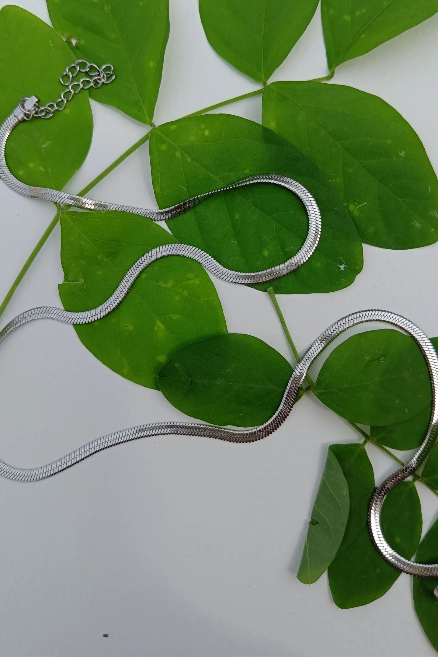 Second image of an anti tarnish silver chain necklace featuring a snake like design.