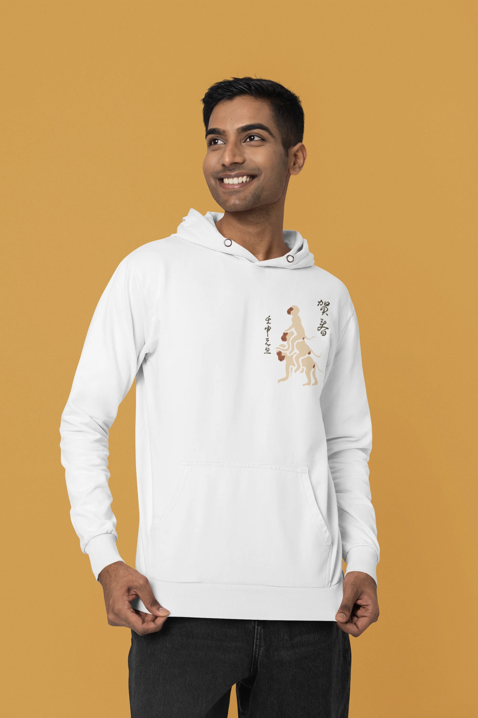First front view of a male model wearing a white hoodie with a design of the three wise monkeys: "See no evil, hear no evil, speak no evil."