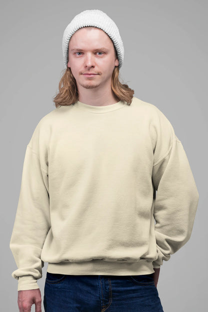 First front view of a male model wearing an cream sweatshirt featuring colorful "Dream Without Limits" text, offering an inspiring and uplifting aesthetic.
