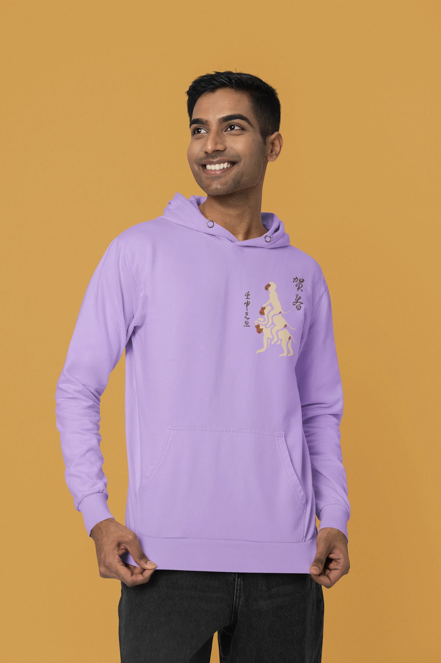 First front view of a male model wearing a lavender hoodie with a design of the three wise monkeys: "See no evil, hear no evil, speak no evil."